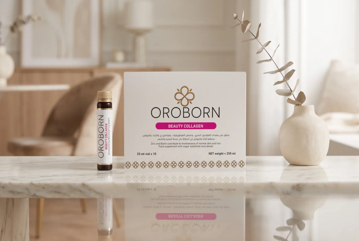 عبوة وقارورة OROBORN Beauty Collagen باللغتين العربية والإنجليزية على طاولة رخامية